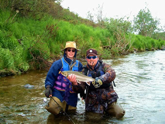 Young boy winches in a tasteeee CHAR - ALASKA RAFT CONNECTION